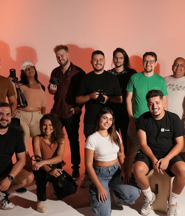 Diverse group of smiling people in a bright, modern studio.